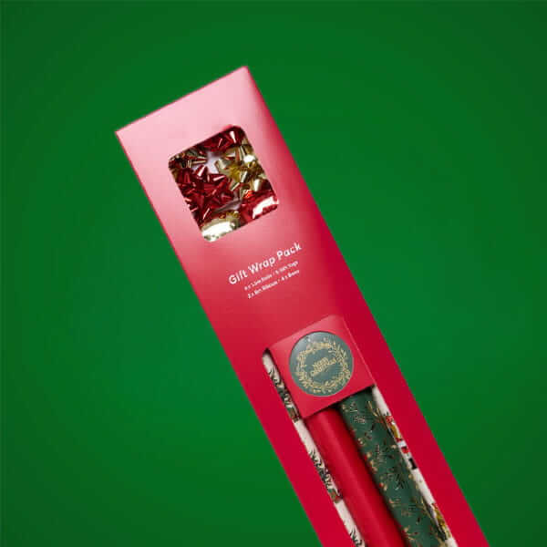 Christmas gift wrap pack featuring festive wrapping paper, gift tags and decorative bows, displayed against a green background.
